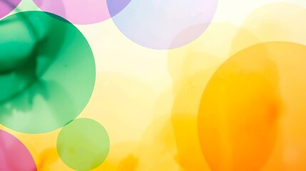 Abstract blurred macro background featuring soft bubble-like circular shapes in green, blue, and violet tones over a bright orange and yellow gradient.