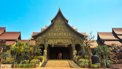 Obraz premium Grand entrance of the Lao Art Museum with intricate wood carvings and elephant statue, Vientiane, Laos 