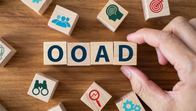 OOAD acronym on wooden blocks surrounded by business and technology icons, representing Object-Oriented Analysis and Design concepts for software development and project management
