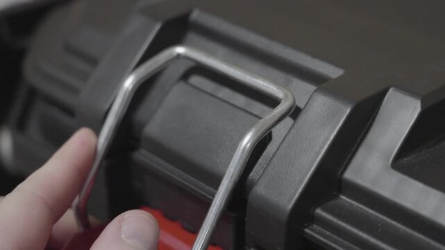 Closing the hinge on a large tool box.