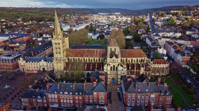 Saint-Pierre Cathedral, reveal the formal Bishop's Garden, Lisieux in Normandy, France. Aerial drone ascending tilt down