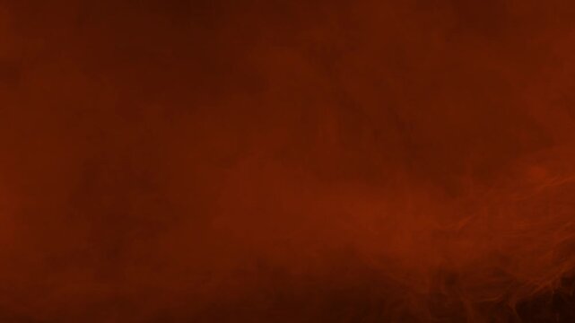 Orange ember fog and smoke creating a dense texture on black background, seamless loop