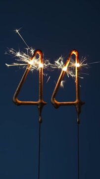 44 years celebration festive background made with Bengal fires in the form of number Forty four. Vertical video.