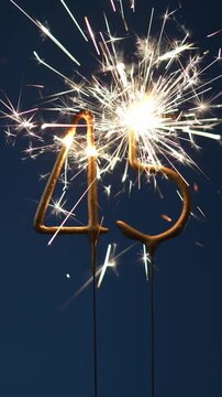 45 years celebration festive background made with Bengal fires in the form of number Forty five. Vertical video.