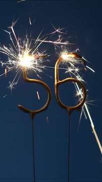 56 years celebration festive background made with Bengal fires in the form of number Fifty six. Vertical video.