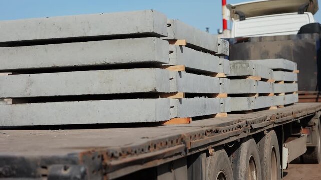 Stacked precast concrete slabs on truck trailer at construction site