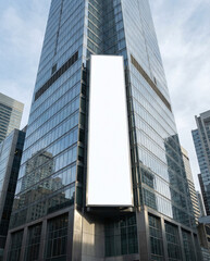 Obraz premium Blank Vertical large Billboard Mockup on Modern Glass Skyscraper Building