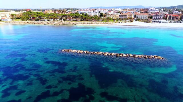 Panoramic drone view of Alghero coastline in Sardinia on a sunny morning with clear sea coastal landscape and mediterranean scenery
