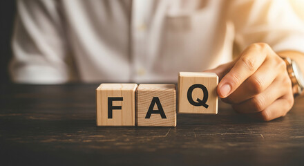 Naklejka premium Person hand arranging wooden blocks spelling FAQ perfect for business customer service and internet support helpdesk