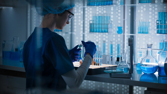 Female researcher in protective wear sorting samples