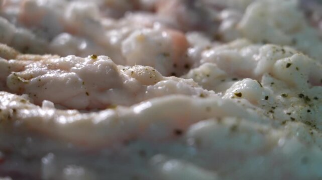 Close-up of raw beef large intestine sprinkled with pepper powder