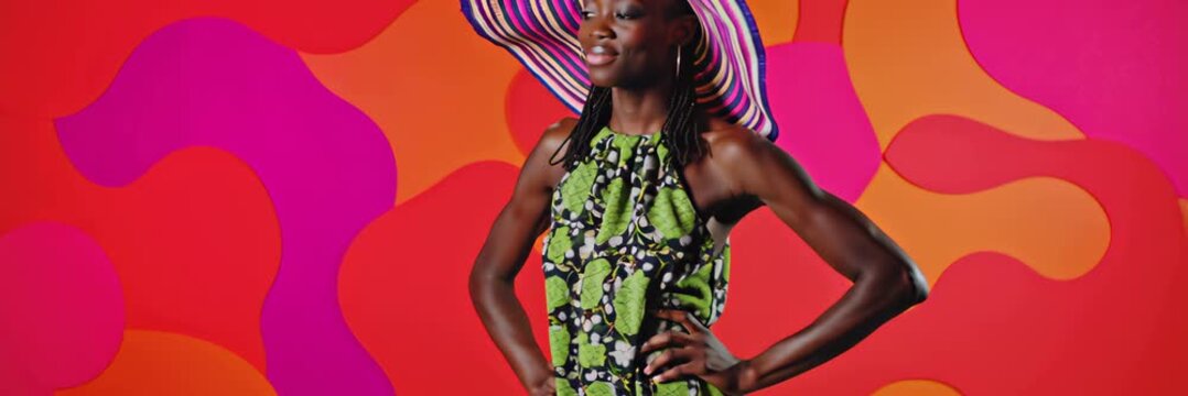 African woman wearing colorful hat posing against vibrant background, stylish fashion portrait and beauty concept in wide banner format for website.