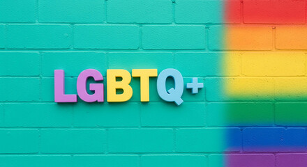 Obraz premium Colorful LGBTQ+ letters on green brick wall with rainbow paint, representing diversity, inclusion, and community support, perfect for social awareness