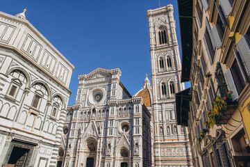 Fototapeta premium Florence Duomo complex, Giotto's Bell Tower, Florence Baptistery and historic architecture under blue sky in Italy