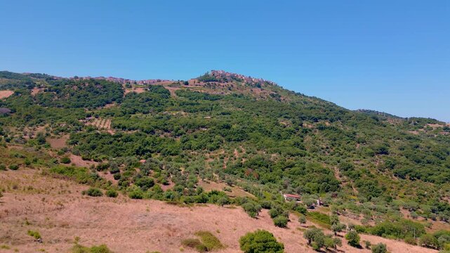 Cinematic aerial drone panorama of Tusa, Sicily. Historic hill town overlooking the Tyrrhenian coast with traditional Mediterranean architecture, scenic mountain landscape and panoramic views