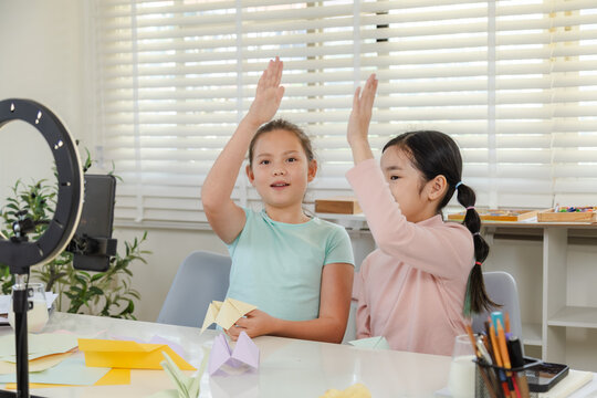 Children online learning content creator, elementary girls explain homework to teacher record creative activity and phone, digital education, creativity vlog, modern alpha generation study lifestyle