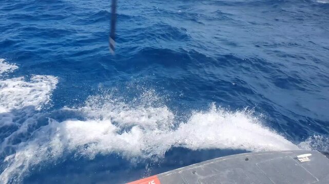 Seaplane landing on ocean surface creating waves in Maldives tropical sea