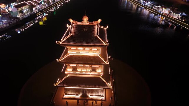 Aerial view of ancient hoa lu pagodas on the lake at night in ninh binh, vietnam