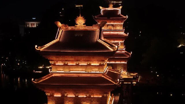 Ancient pagodas in hoa lu at night reflecting on the river, ninh binh, vietnam aerial view