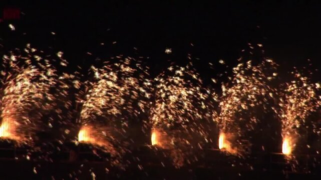 Animation of glitch effect over golden fireworks exploding against black background