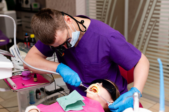 Dental professional focused on patient care during an afternoon procedure in a modern clinic with advanced equipment and comforting atmosphere