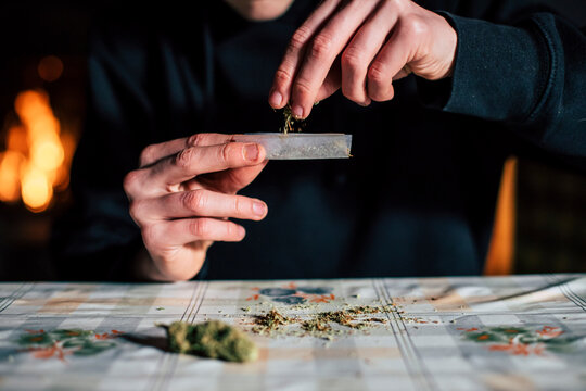 Close-up of a man's hands preparing marihuana joint