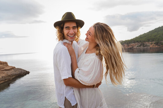 Portrait of young couple in love standing in front of the sea, Ibiza, Balearic Islands, Spain