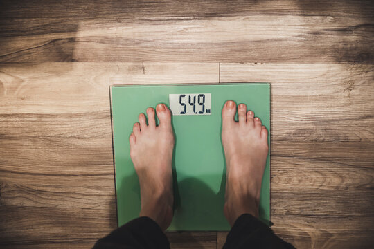 Close-up of woman standing on scales