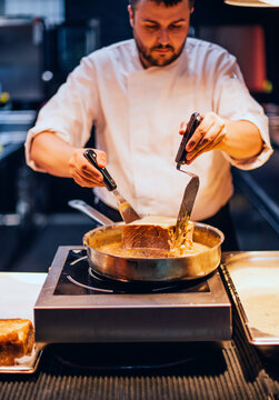 Chef creating a cake in the kitchen of a restaurant