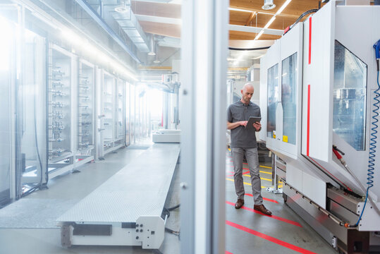 Man using tablet in modern factory