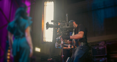 Steadicam Operator Filming Beautiful Woman in Studio with Copy Space
