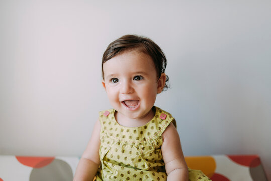 Portrait of happy baby girl wearing a dress