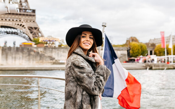 Paris, France, portrait o f tourist taking a cruise on Seine River with Eiffel Tower in the background