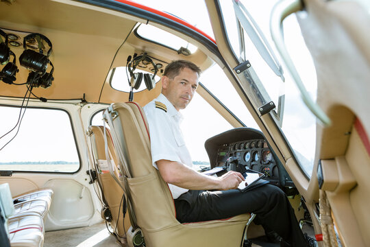 Portrait of pilot in cockpit of a helicopter