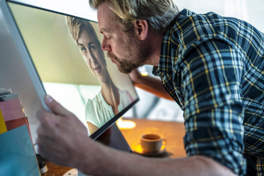Man kissing woman on computer screen