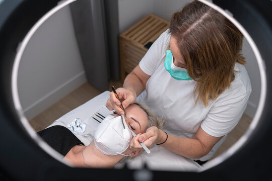 Female beautician giving beauty treatment to customer at spa