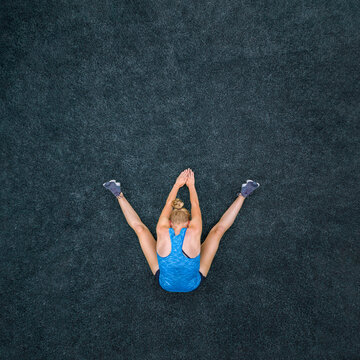 Young woman doing gymnastics, top view