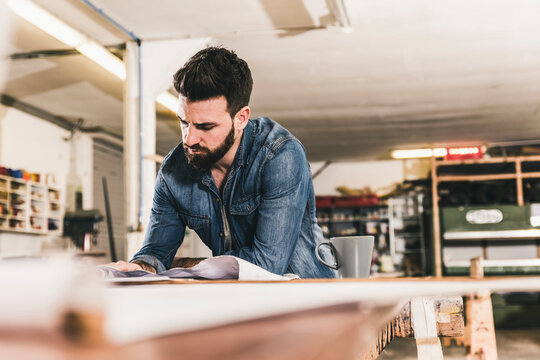Man looking at draft in workshop