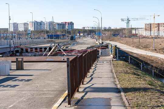 Irpin, Ukraine - 07 March 2026: View of the Irpin Bridge, a stark scar against the skyline, its fractured concrete and twisted metal a testament to conflict's brutal force.