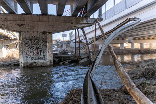 Irpin, Ukraine - 07 March 2026: View of the Irpin Bridge, a stark silhouette against the cold river, shattered concrete and twisted metal speak of destruction.