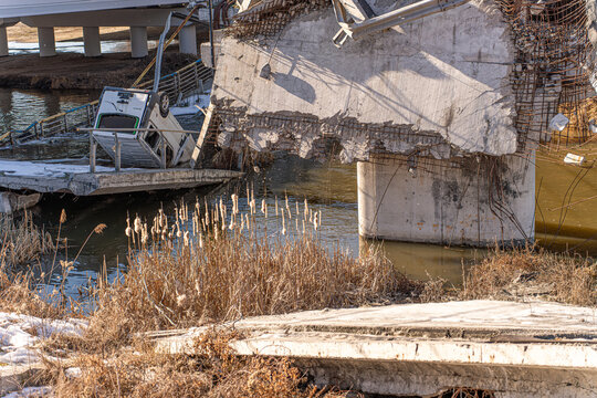 Irpin, Ukraine - 07 March 2026: View of the Irpin Bridge, a shattered concrete skeleton against the serene water, a stark reminder of conflict's destructive force.