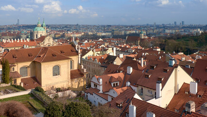 St Nicholas Church and Mal&aacute; Strana red tile rooftops overlooking Prague skyline