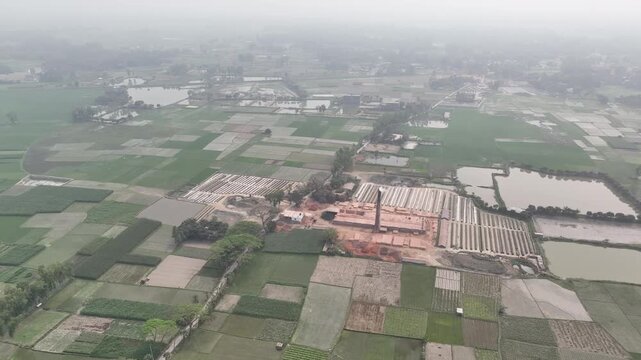 Aerial view of brick kiln emitting smoke in rural area