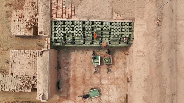 Aerial view of manual laborers working in brickyard