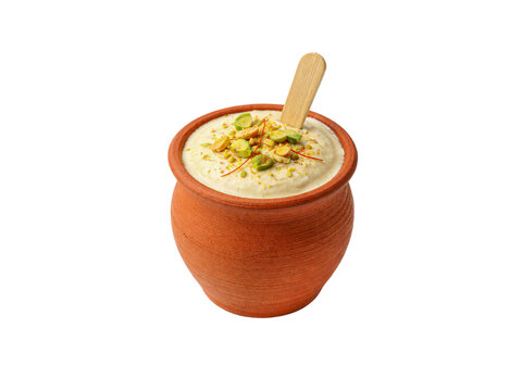 Matka kulfi traditional indian ice cream in clay pot with pistachio and saffron isolated on white background.