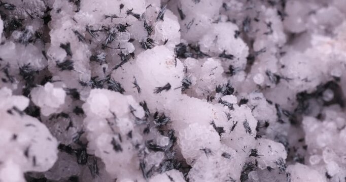 Black Manganite on Calcite. Specimen from N'Chwaning II Mine, Kalahari Manganese Field, South Africa. macro footage detail texture background. close-up mineral crystal unpolished semi-precious
