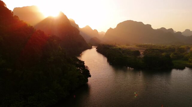 Aerial view of river in ninh binh province, vietnam. Golden sunset light shining over the iconic limestone cliffs