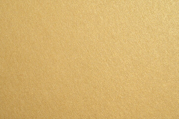 Golden shimmering background texture creating sparkling abstract pattern, glittering surface for luxury design concepts