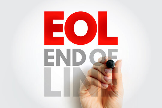 EOL END OF LINE text on paper with pen in hand, symbolizing software development, text structure, coding syntax, and data formatting in programming