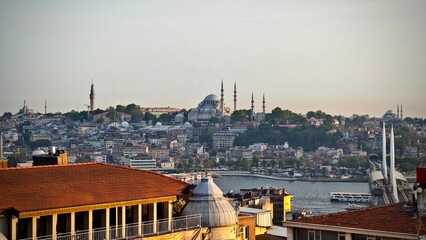 Panoramic view of Istanbul, Turkey, showcasing the city's skyline with historical architecture. The Suleymaniye Mosque, with its large dome and multiple minarets, stands prominently on a hillside.  © Julija